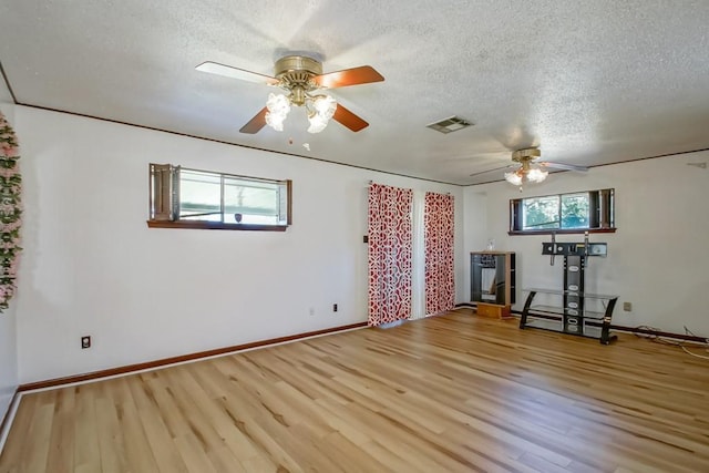2219 Mercedes Blvd, New Orleans, LA 70114 - unfurnished living room featuring a ceiling fan, a textured ceiling, and wood finished floors