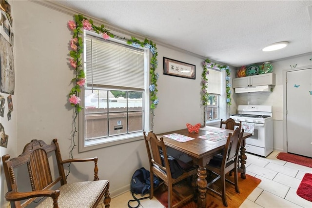 1500 Shirley Dr, New Orleans, LA 70114 - dining area with plenty of natural light, a textured ceiling, ornamental molding, and light tile patterned floors