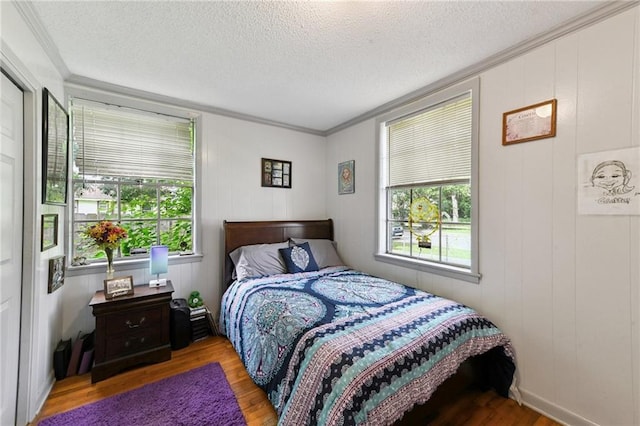 1500 Shirley Dr, New Orleans, LA 70114 - bedroom featuring wood finished floors, multiple windows, a textured ceiling, and crown molding