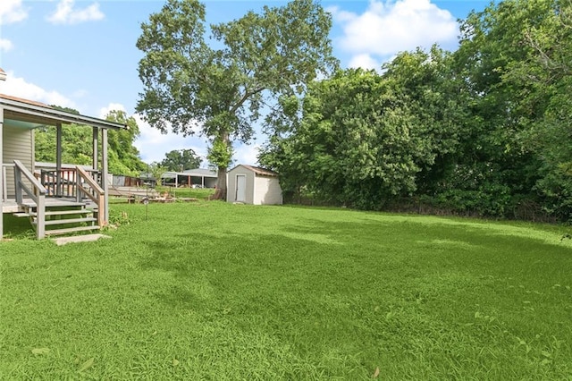 1117 Perry St, Gretna, LA 70053 - view of green lawn with a storage shed and a wooden deck