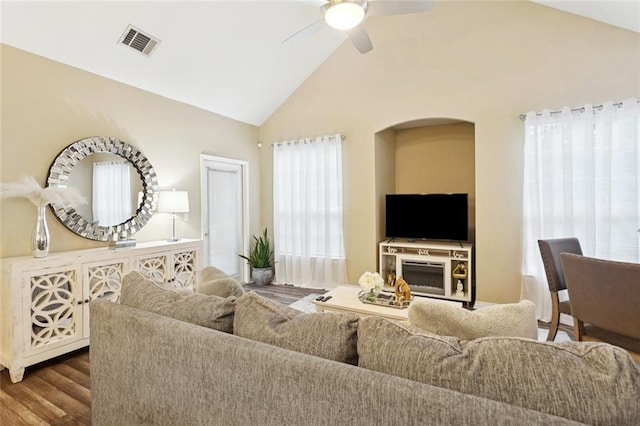 521 Spartan Dr Unit 10207, Slidell, LA 70458 - living area with healthy amount of natural light, a ceiling fan, wood finished floors, arched walkways, and high vaulted ceiling