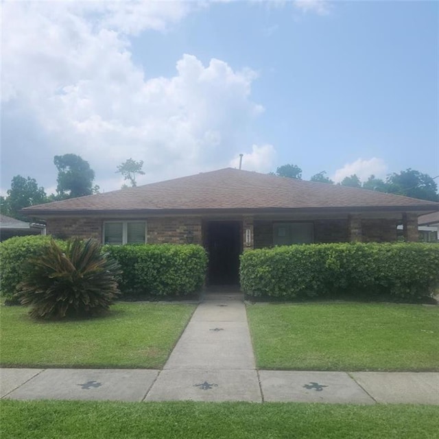 3020 Maureen Ln, Meraux, LA 70075 - ranch-style home featuring a front lawn, a shingled roof, and brick siding