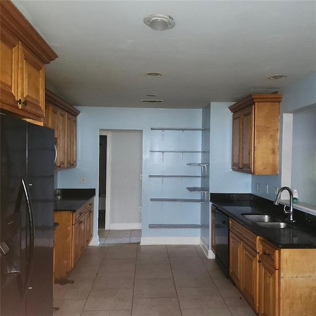 3020 Maureen Ln, Meraux, LA 70075 - kitchen featuring black appliances, brown cabinets, dark countertops, and light tile patterned flooring