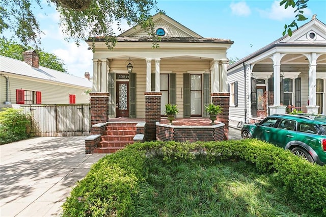 3354 Esplanade Ave, New Orleans, LA 70119 - shotgun-style home featuring covered porch and brick siding