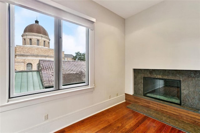 3354 Esplanade Ave, New Orleans, LA 70119 - unfurnished living room featuring wood finished floors and a glass covered fireplace