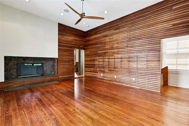 3354 Esplanade Ave, New Orleans, LA 70119 - unfurnished living room with a fireplace, a ceiling fan, wood finished floors, wood walls, and recessed lighting