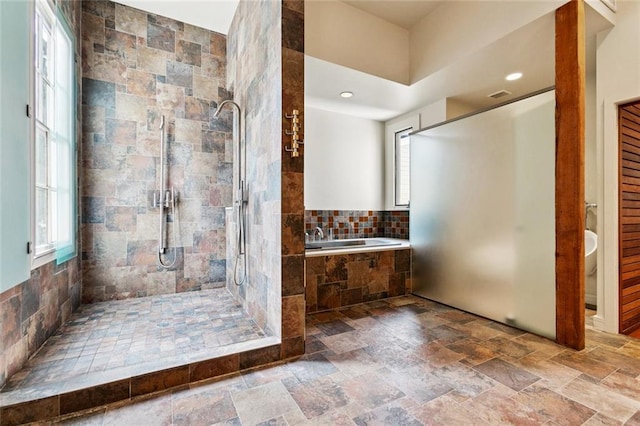 3354 Esplanade Ave, New Orleans, LA 70119 - bathroom with a bath, a stall shower, stone tile floors, and recessed lighting