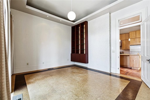 3354 Esplanade Ave, New Orleans, LA 70119 - spare room with inlaid floor details and a tray ceiling