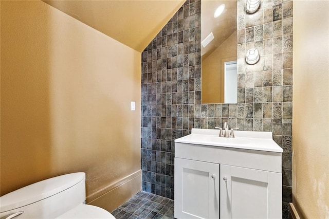 3354 Esplanade Ave, New Orleans, LA 70119 - bathroom with tile walls, lofted ceiling, and vanity