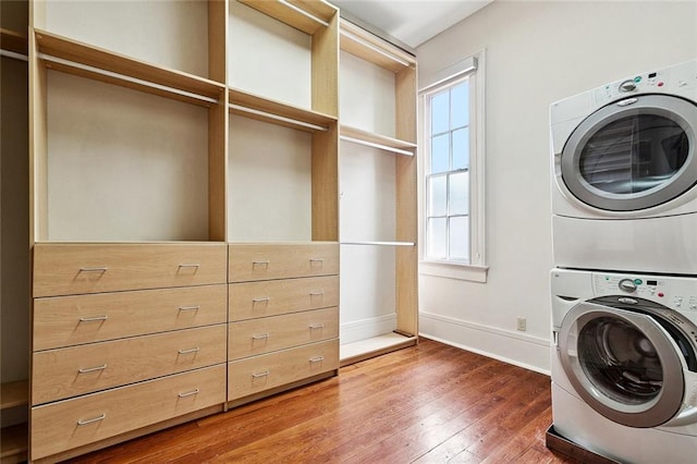 3354 Esplanade Ave, New Orleans, LA 70119 - washroom featuring estacked washer and dryer and hardwood / wood-style floors