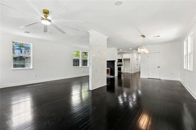 1314 Adams St, New Orleans, LA 70118 - unfurnished living room with plenty of natural light, dark wood-style floors, ceiling fan, a fireplace, and crown molding
