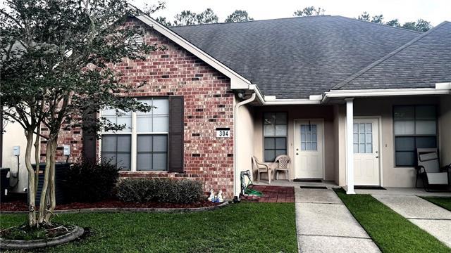 40145 Taylors Trl Unit 304, Slidell, LA 70461 - view of front of home featuring brick siding, a shingled roof, and a front lawn