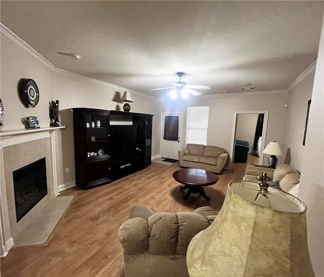 40145 Taylors Trl Unit 304, Slidell, LA 70461 - living room with wood finished floors, ornamental molding, a high end fireplace, and ceiling fan