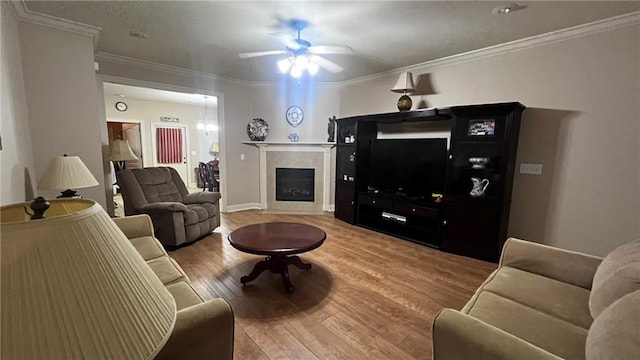 40145 Taylors Trl Unit 304, Slidell, LA 70461 - living room featuring ceiling fan, wood finished floors, crown molding, and a tile fireplace