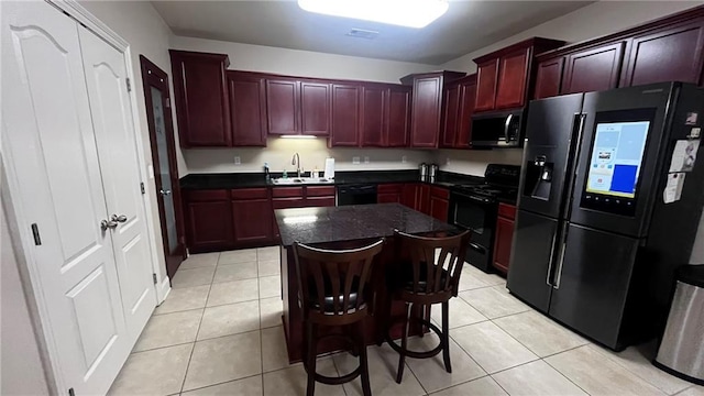 40145 Taylors Trl Unit 304, Slidell, LA 70461 - kitchen with black appliances, reddish brown cabinets, dark countertops, and a kitchen island