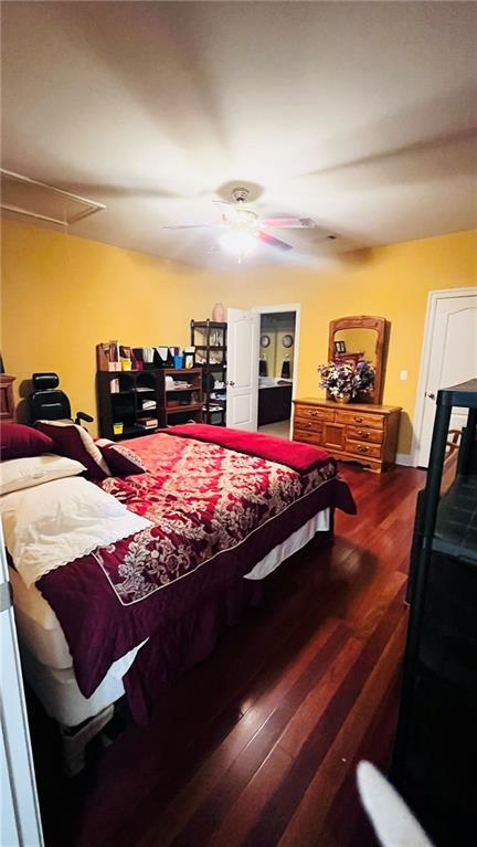 40145 Taylors Trl Unit 304, Slidell, LA 70461 - bedroom with attic access, wood finished floors, and a ceiling fan