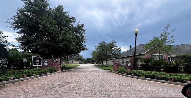 40145 Taylors Trl Unit 304, Slidell, LA 70461 - view of decorative street featuring curbs, street lights, and a gate