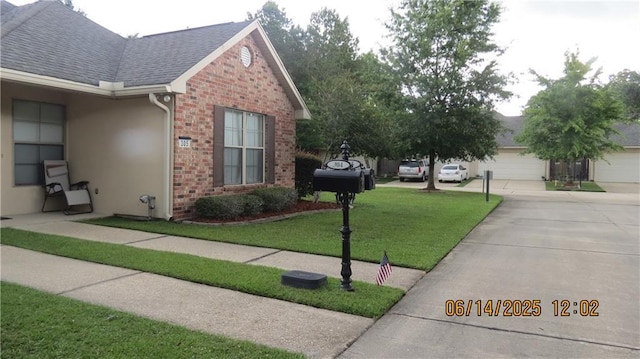 40145 Taylors Trl Unit 304, Slidell, LA 70461 - view of side of property with a lawn, brick siding, roof with shingles, concrete driveway, and stucco siding
