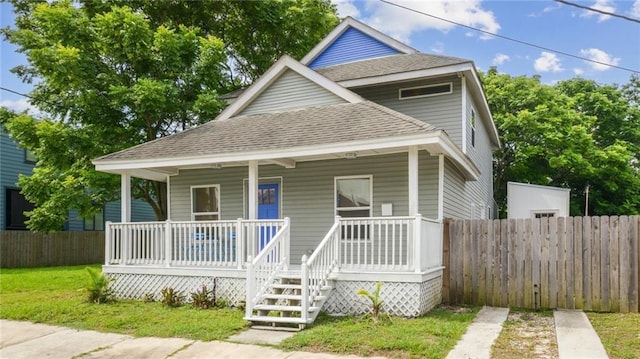 3606 N Miro St, New Orleans, LA 70117 - view of front facade featuring roof with shingles and a porch