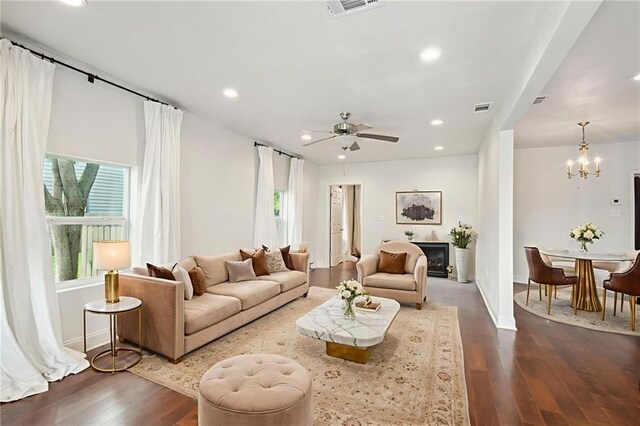 3606 N Miro St, New Orleans, LA 70117 - living room featuring a chandelier, dark wood-type flooring, recessed lighting, a ceiling fan, and a fireplace