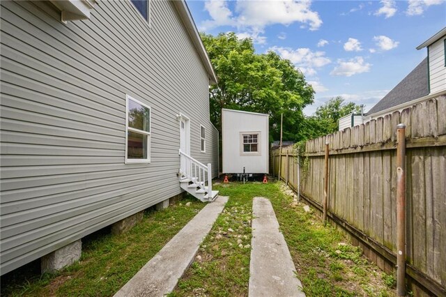 3606 N Miro St, New Orleans, LA 70117 - view of yard with entry steps and an outbuilding