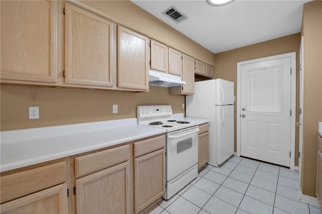 70405 F St, Covington, LA 70433 - kitchen featuring white appliances and light brown cabinetry