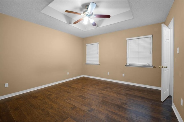 70405 F St, Covington, LA 70433 - empty room with a tray ceiling, dark wood-style floors, and ceiling fan
