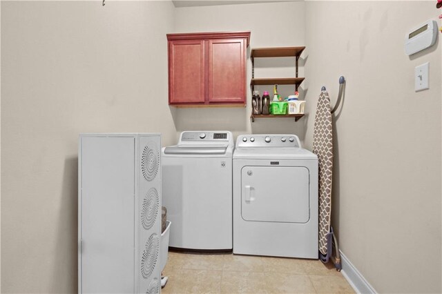 855 Woodsprings Ct, Covington, LA 70433 - laundry room with washing machine and dryer, cabinet space, and light tile patterned floors