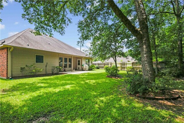855 Woodsprings Ct, Covington, LA 70433 - rear view of house with a patio and roof with shingles