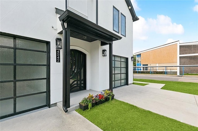 4542 Prairie St, Metairie, LA 70001 - entrance to property featuring stucco siding, concrete driveway, and an attached garage