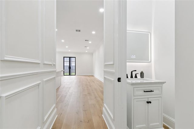 4542 Prairie St, Metairie, LA 70001 - corridor featuring light wood-type flooring, recessed lighting, and crown molding