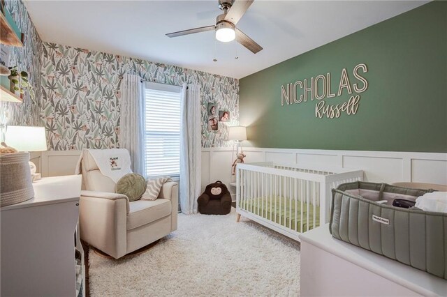 1112 Compromise St, Kenner, LA 70062 - bedroom featuring wallpapered walls, wainscoting, a decorative wall, a crib, and carpet flooring