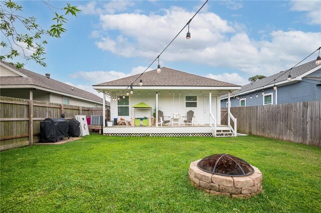 1112 Compromise St, Kenner, LA 70062 - back of property featuring a fire pit, a fenced backyard, and roof with shingles