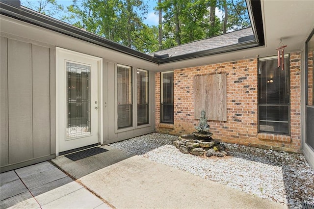 285 Oak Dr, Mandeville, LA 70471 - property entrance with brick siding, a patio area, and board and batten siding