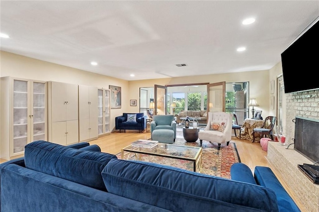 285 Oak Dr, Mandeville, LA 70471 - living area featuring light wood-style flooring, recessed lighting, and a fireplace