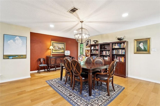 285 Oak Dr, Mandeville, LA 70471 - dining room featuring a chandelier, light wood-style floors, and recessed lighting