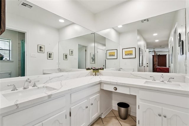 285 Oak Dr, Mandeville, LA 70471 - ensuite bathroom with double vanity, tile patterned floors, and recessed lighting