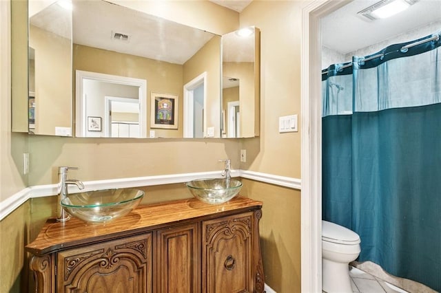 285 Oak Dr, Mandeville, LA 70471 - full bathroom with double vanity, a shower with curtain, and tile patterned flooring