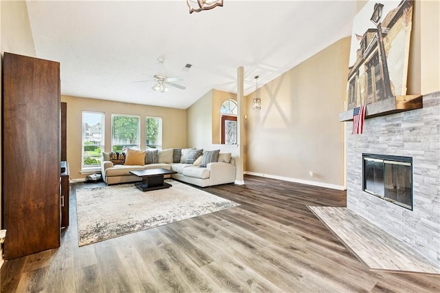 310 Oakley Ln, Destrehan, LA 70047 - living room featuring a ceiling fan, a fireplace, wood finished floors, and vaulted ceiling