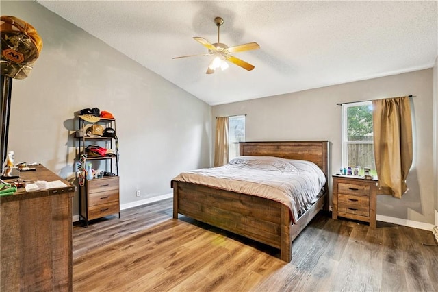 310 Oakley Ln, Destrehan, LA 70047 - bedroom featuring vaulted ceiling, wood finished floors, a textured ceiling, and a ceiling fan