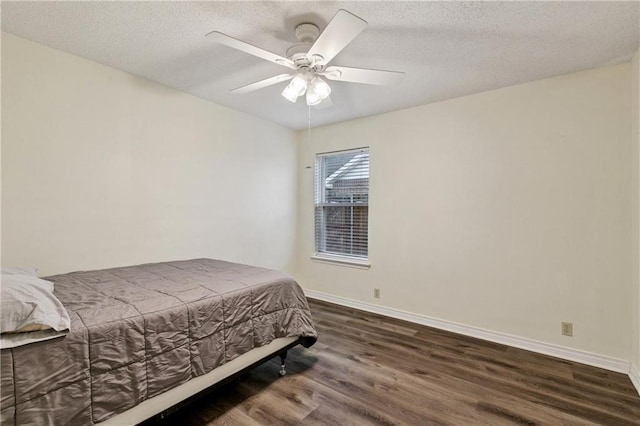 310 Oakley Ln, Destrehan, LA 70047 - bedroom featuring dark wood finished floors, a textured ceiling, and ceiling fan
