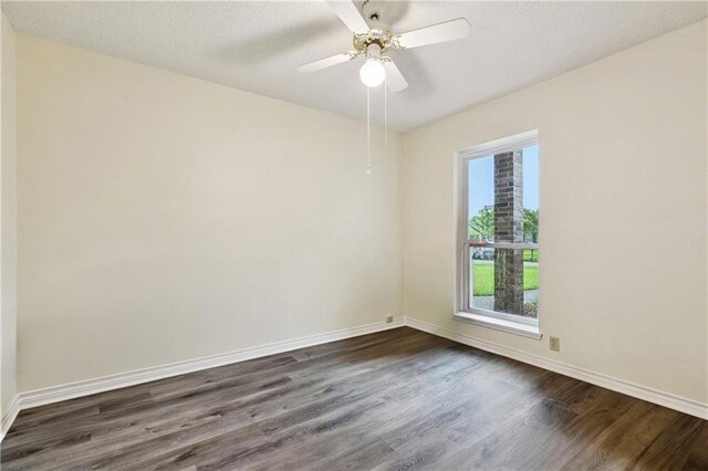 310 Oakley Ln, Destrehan, LA 70047 - empty room featuring dark wood-style flooring, healthy amount of natural light, ceiling fan, and a textured ceiling