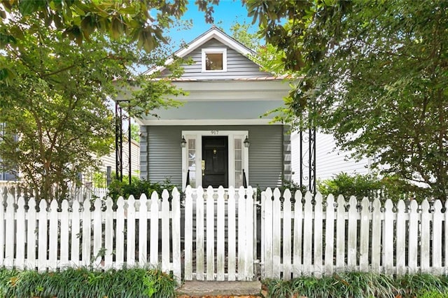 917 Joliet St, New Orleans, LA 70118 - shotgun-style home featuring a fenced front yard