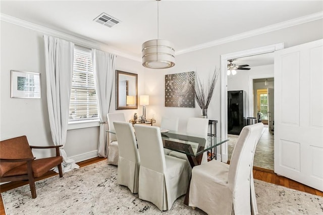 917 Joliet St, New Orleans, LA 70118 - dining area featuring wood finished floors, ornamental molding, and ceiling fan