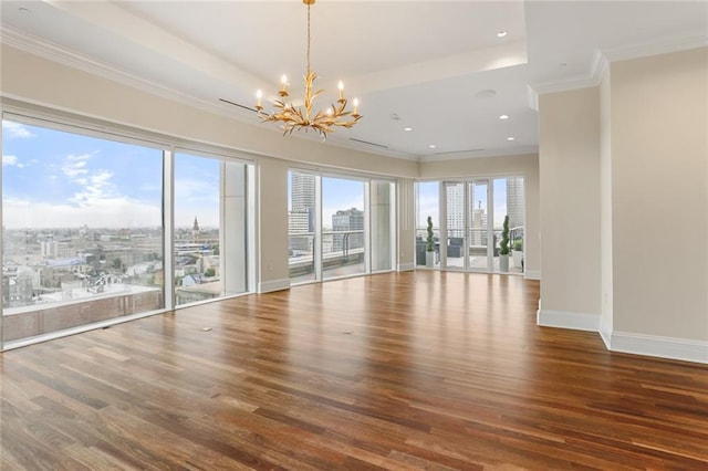 625 St Charles Ave Phd, Phd, New Orleans, LA 70130 - empty room featuring a chandelier, wood finished floors, ornamental molding, recessed lighting, and a view of city