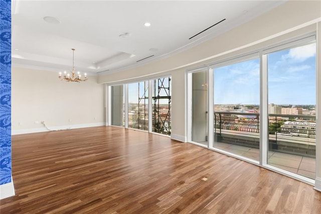 625 St Charles Ave Phd, Phd, New Orleans, LA 70130 - spare room with a chandelier, wood finished floors, ornamental molding, a raised ceiling, and recessed lighting
