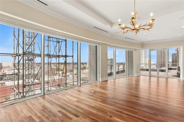 625 St Charles Ave Phd, Phd, New Orleans, LA 70130 - empty room with a chandelier, wood finished floors, ornamental molding, a view of city, and recessed lighting