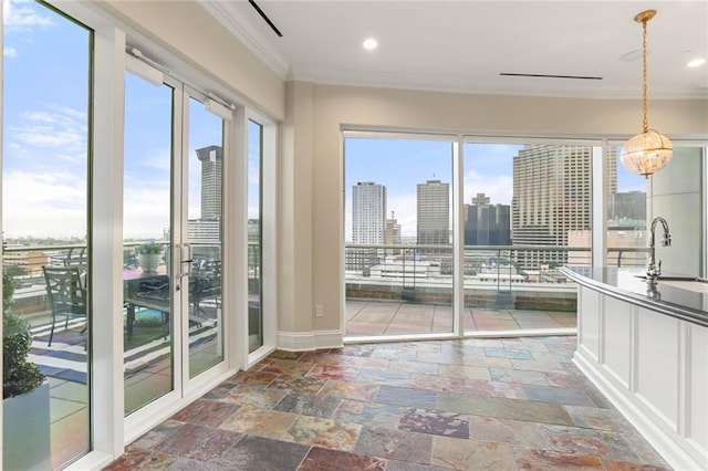 625 St Charles Ave Phd, Phd, New Orleans, LA 70130 - unfurnished sunroom featuring ornamental molding, a skyline view, healthy amount of natural light, stone tile flooring, and recessed lighting