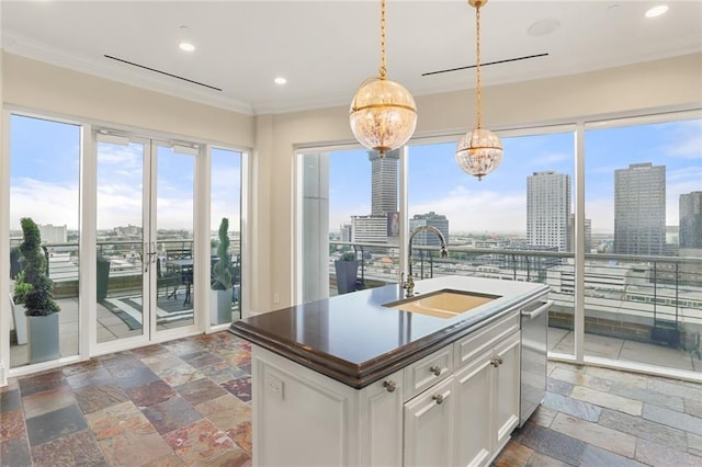 625 St Charles Ave Phd, Phd, New Orleans, LA 70130 - kitchen with dark countertops, stone tile floors, crown molding, a city view, and recessed lighting