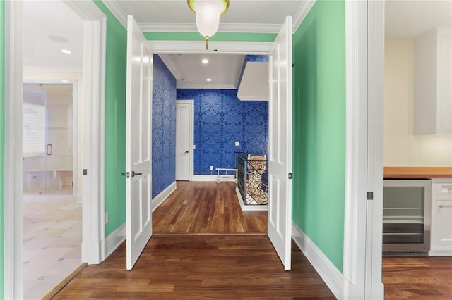 625 St Charles Ave Phd, Phd, New Orleans, LA 70130 - hall with wine cooler, wallpapered walls, dark wood finished floors, and crown molding